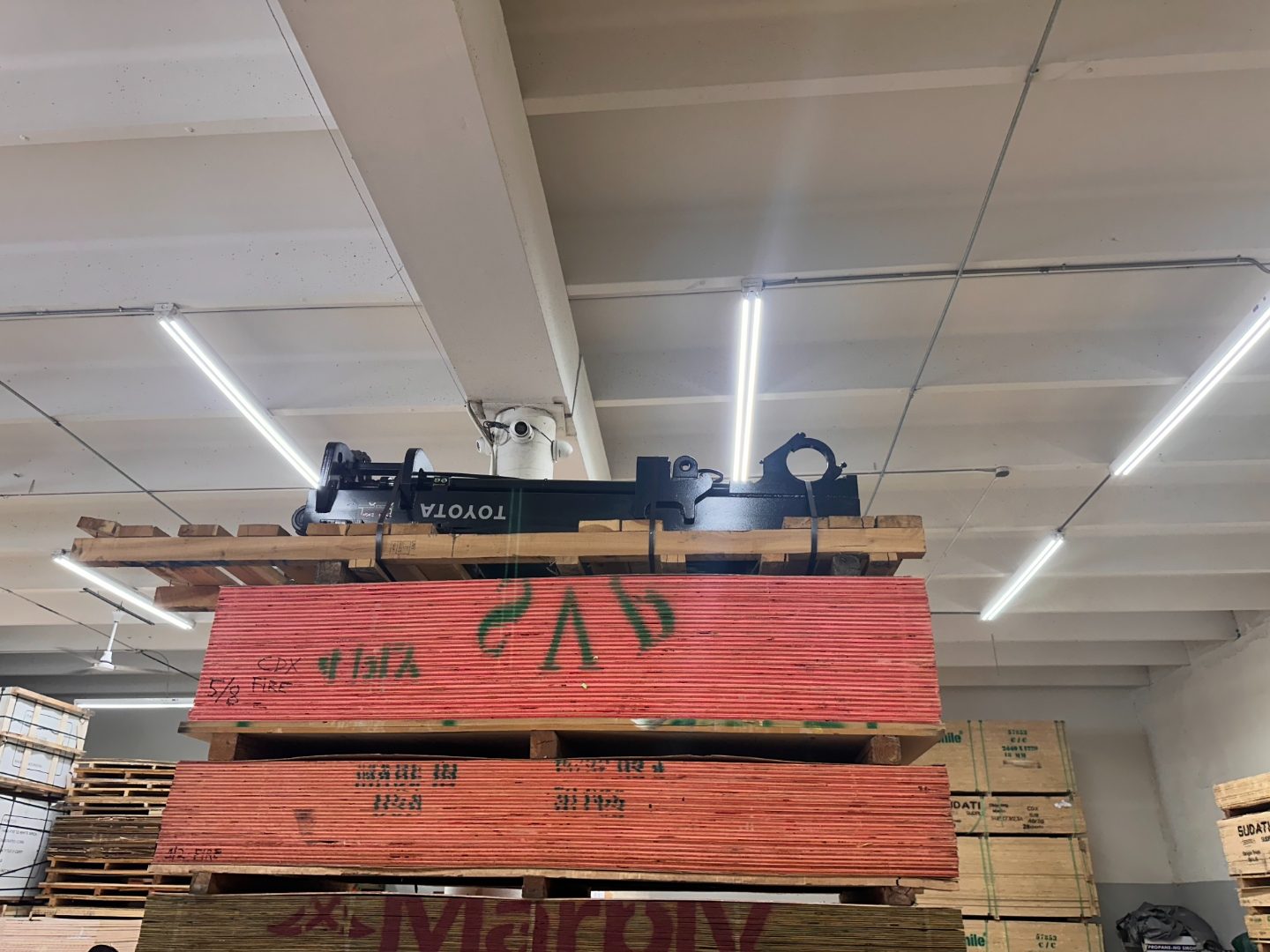 Red CDX fire-retardant plywood panels stacked in Miami warehouse — FRT 5/8 inch in stock for data centers