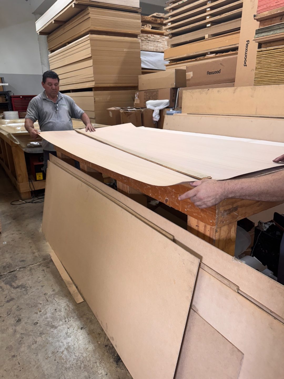 International Plywood staff laying veneers for custom layout service Miami