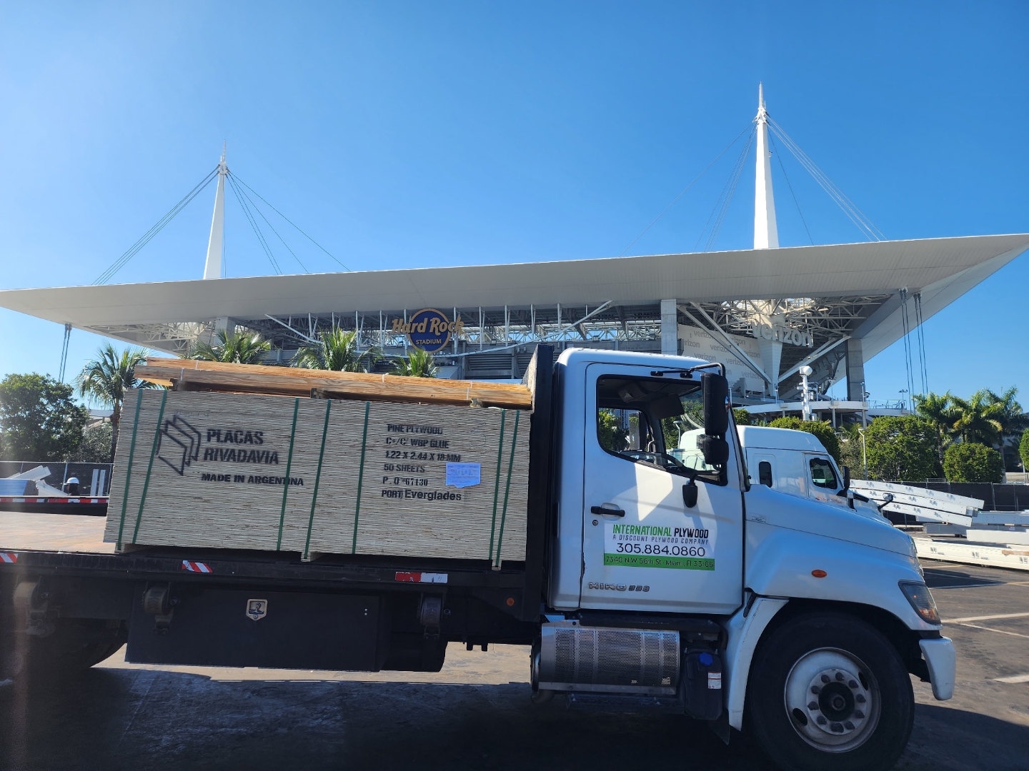 International Plywood flatbed truck delivering plywood at Hard Rock Stadium Miami